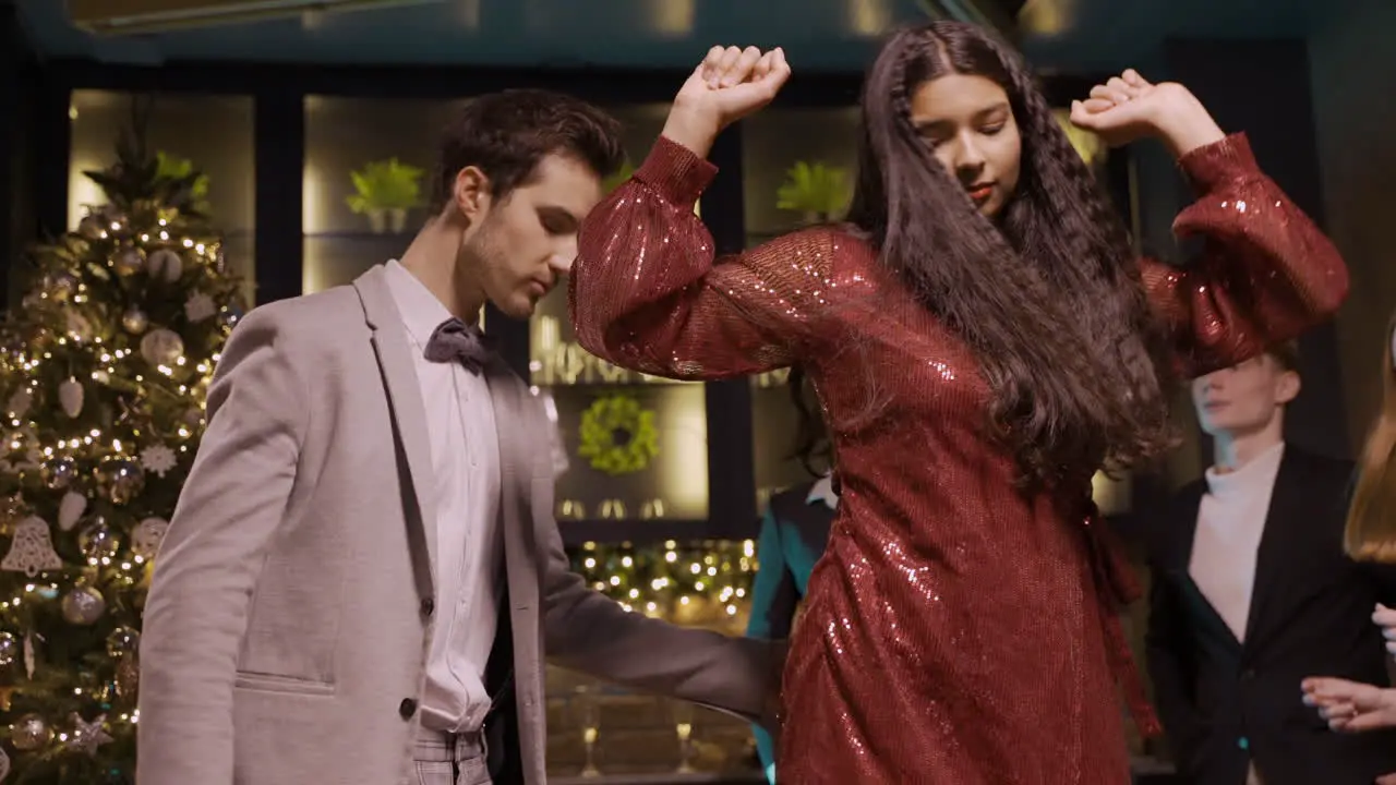 A Couple Dressed In Elegant Clothes Dance At The New Year's Party