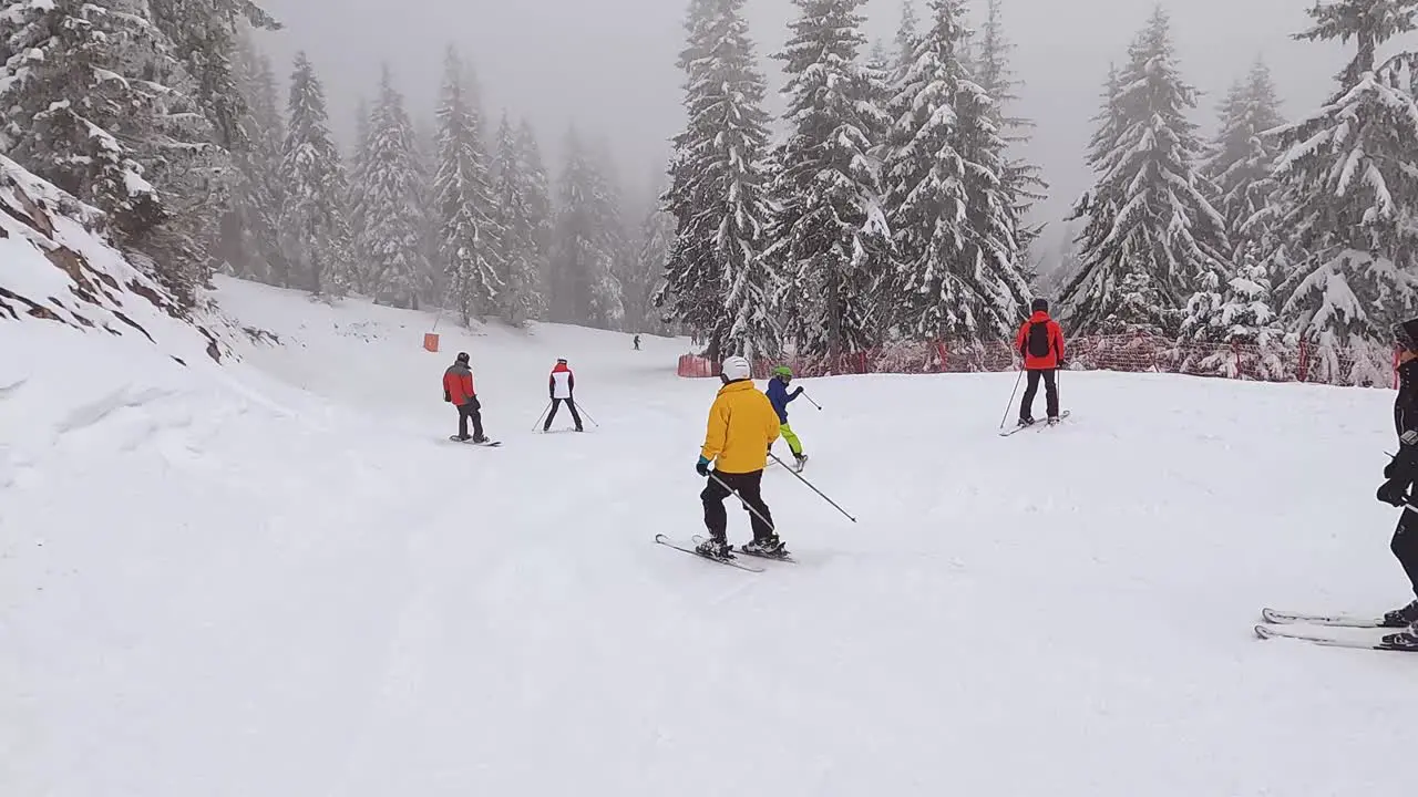 POV Shot Of Skier Skiing Down Misty Snow Covered Mountain