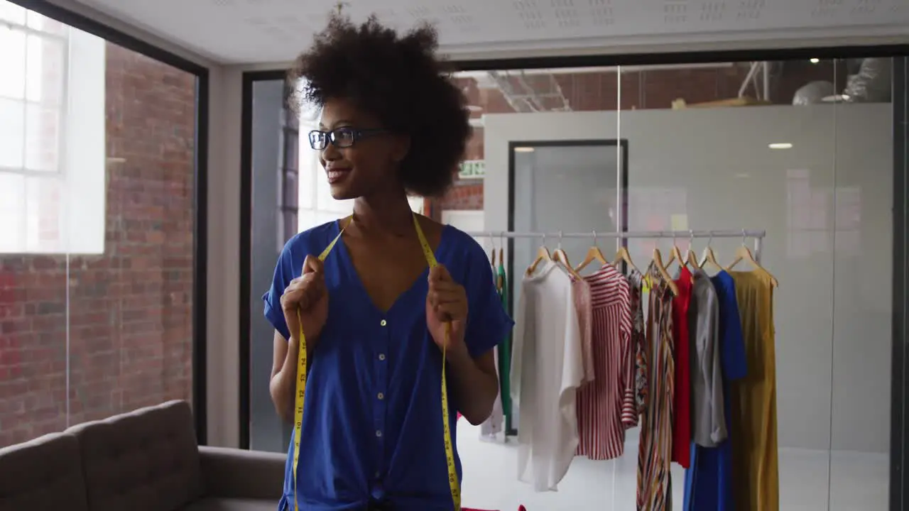 Portrait of african american female fashion designer looking to camera and smiling