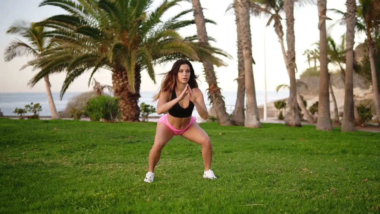 Woman Does Sport Workout In At Tropical Park 1