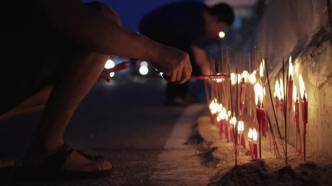 Worshiper Light Up The Red Candle Beside The Road