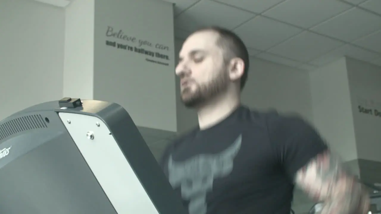 Close Up Low Angle of a Young Man Running on a Treadmill