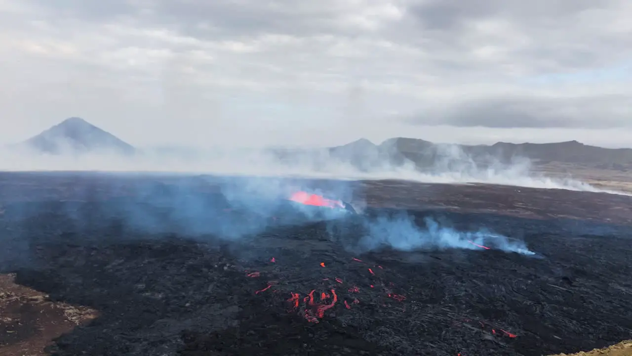 Fagradalsfjall volcano eruption in Iceland with rising smoke aerial drone view