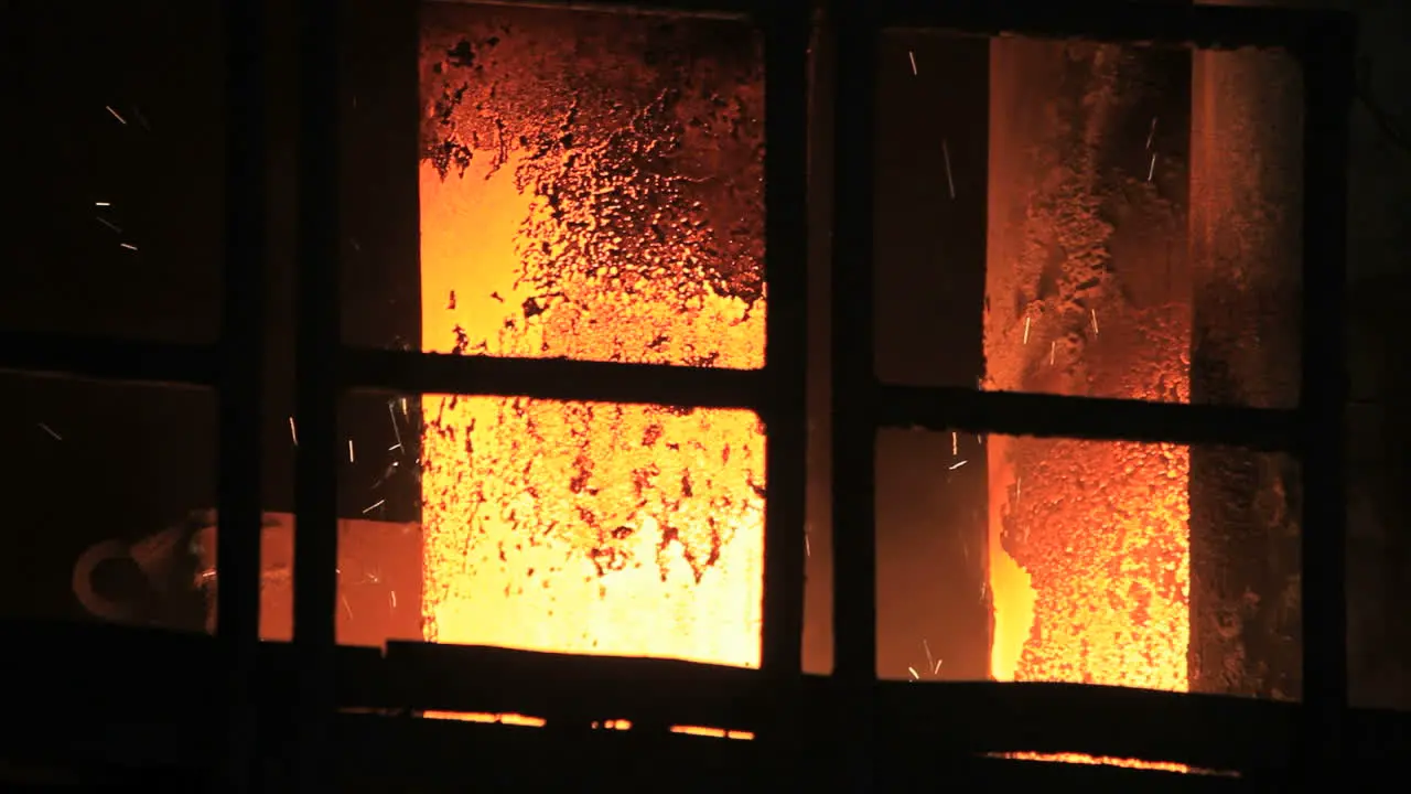 Smelting furnace sparks Hot steel sparks from industrial furnace