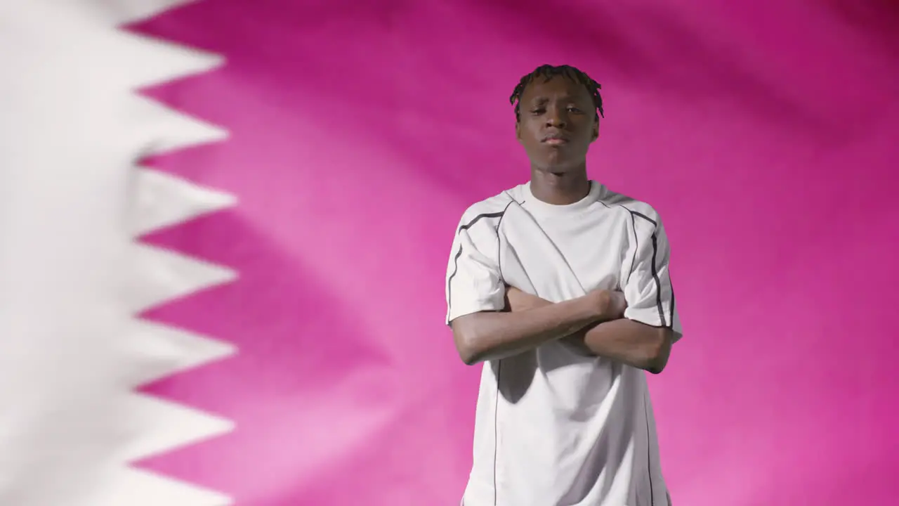 Young Footballer Walking to Camera In Front of Qatar Flag 02