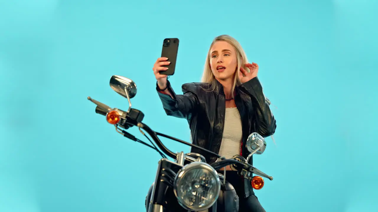 Selfie blue background and woman on motorcycle