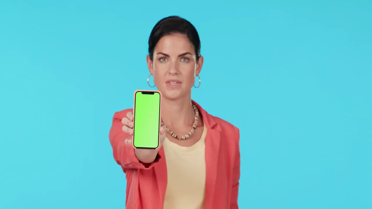 Woman thumbs down and show phone with green