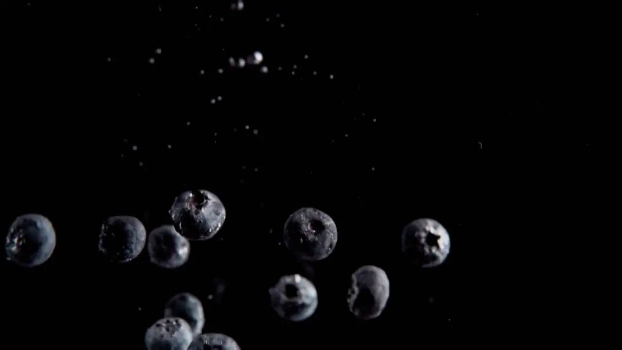 Currants Falling into Water Super Slowmotion Black Background lots of Air Bubbles 4k240fps