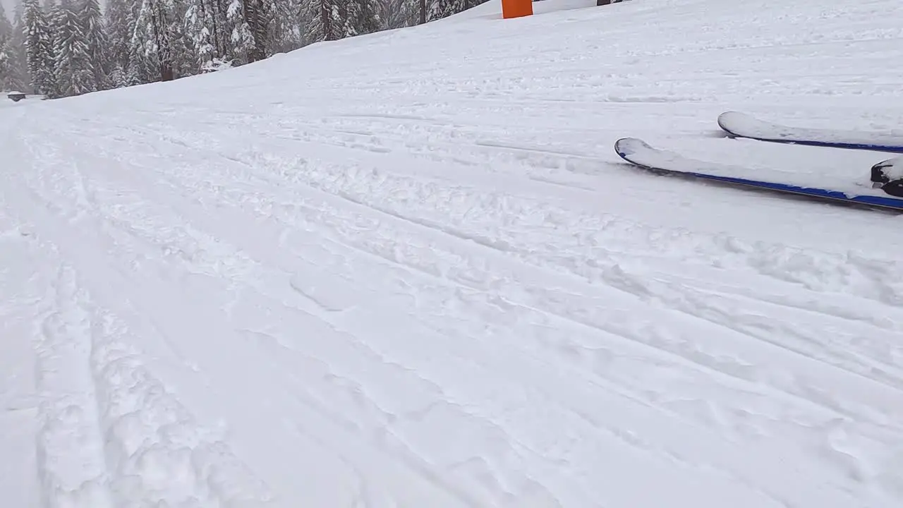 Low Angle POV Shot Of Skier Skiing Down Snow Covered Slope 2