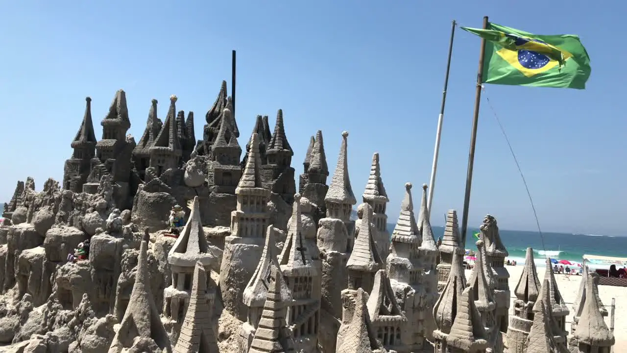 huge sand castle in daylight with the flag of brazil in Rio de Janeiro