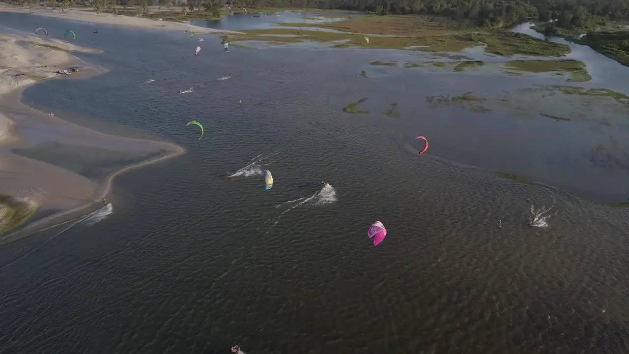 Drone footage of many kiteboarders surfing in Combuco Brazil