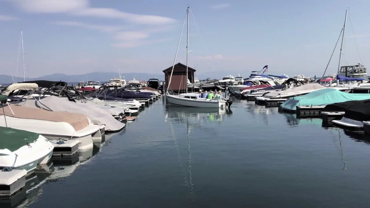 A sailboat backs out of a marina on Lake Tahoe