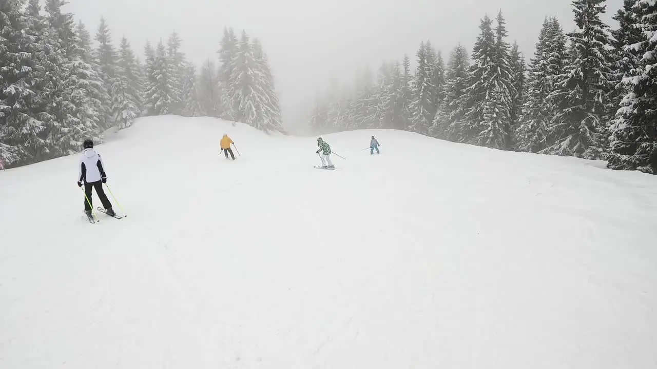 POV Shot Of Skier Skiing Down Misty Snow Covered Mountain With Chair Lift