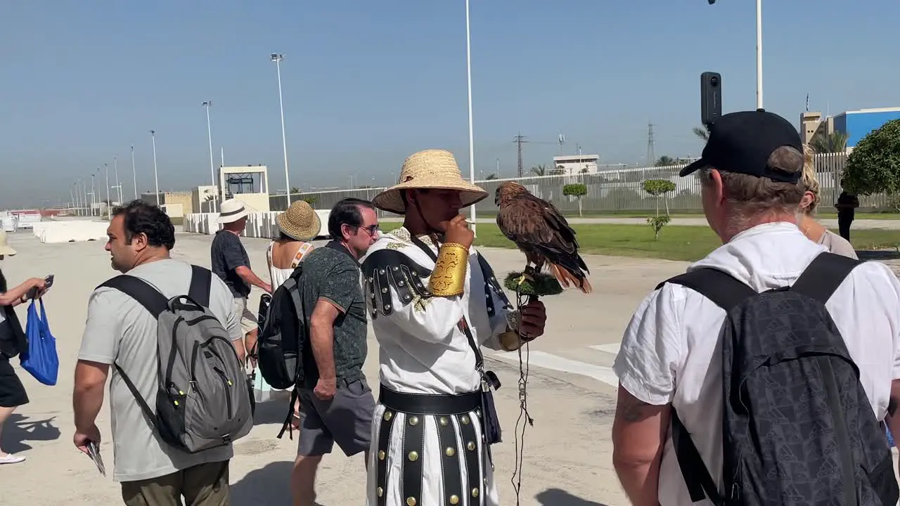 Tourists curiously watch an eagle handler showcase the eagle on an excursion from MSC Grandiosa cruise ship in La Goulette Cruise Port Tunisia