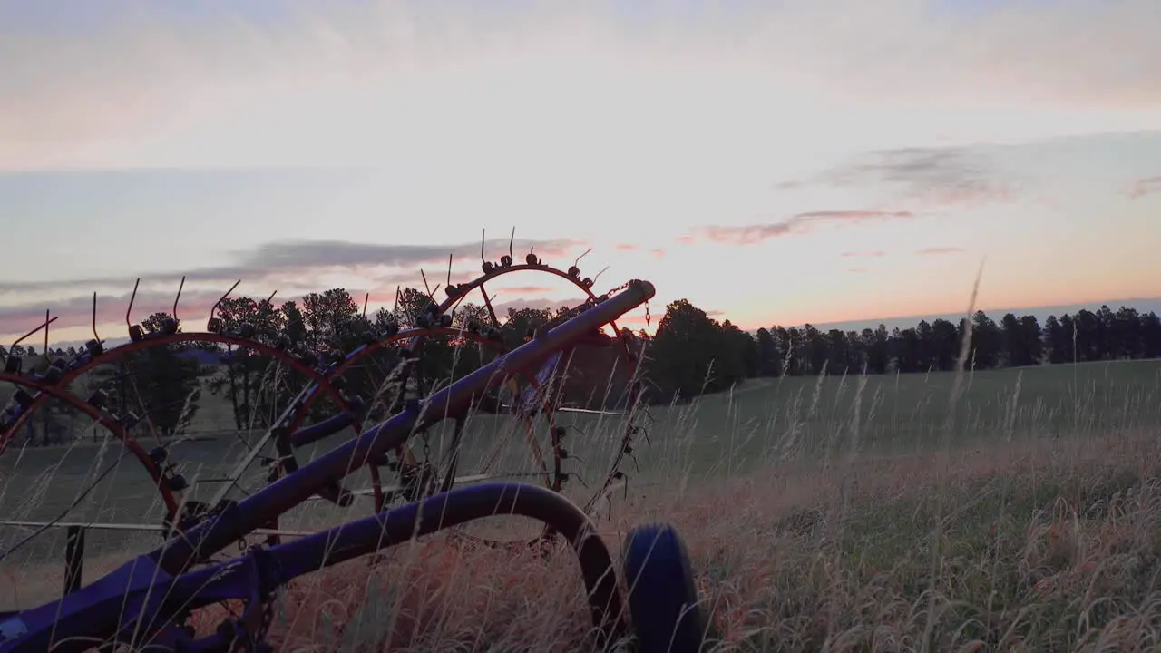 Beautiful sunrise with hay rake in the foreground filmed in eastern montana during early spring