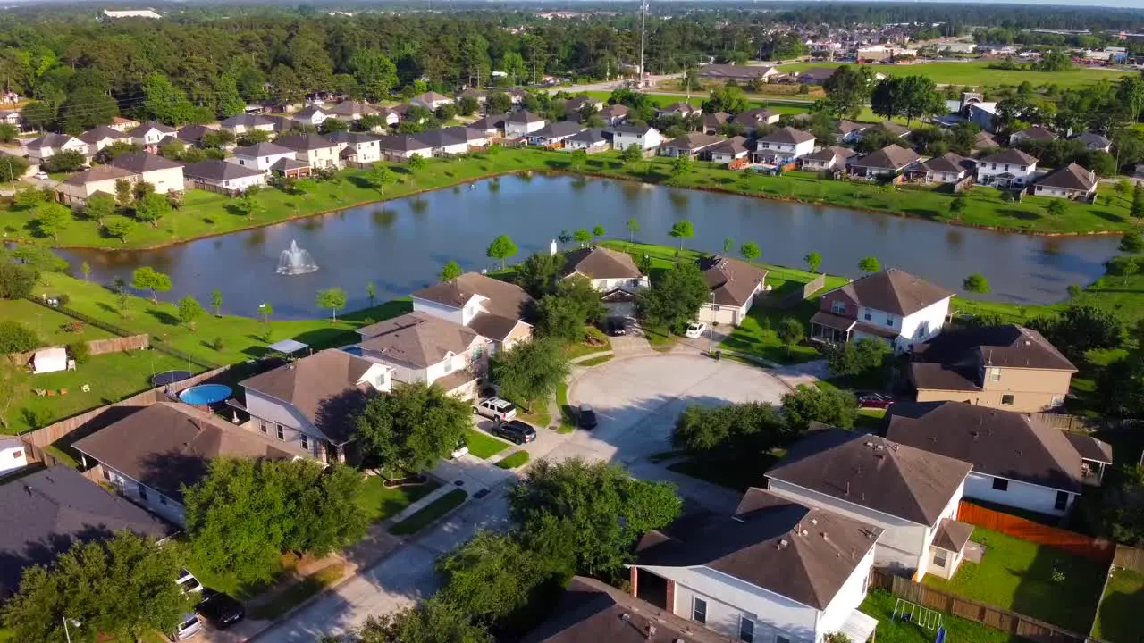 An aerial lake-view of a community of houses located in the suburbs at 60 frames