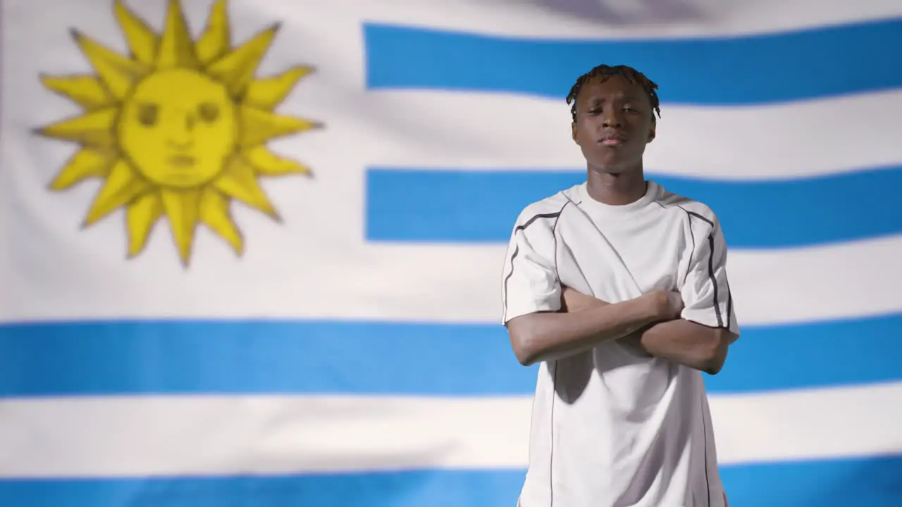 Young Footballer Posing In Front of Uruguay Flag 01