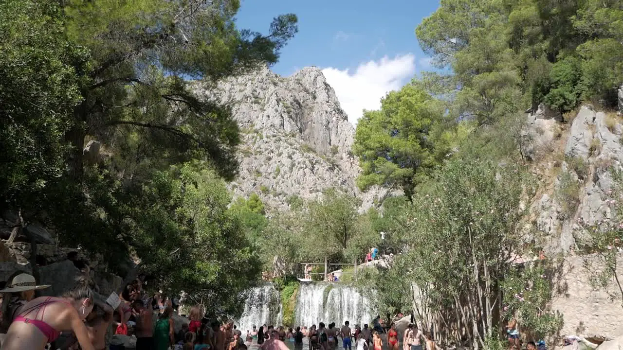 Tourist refreshing at river course in spring water pools at Fonts de L'Algar Alicante Spain