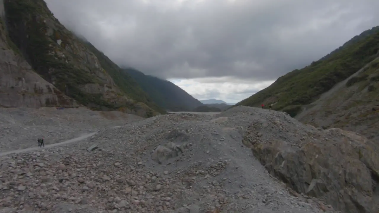 Overview on a rubble landscape with a river on a very cloudy day Franz-Josef Glacier New Zealand