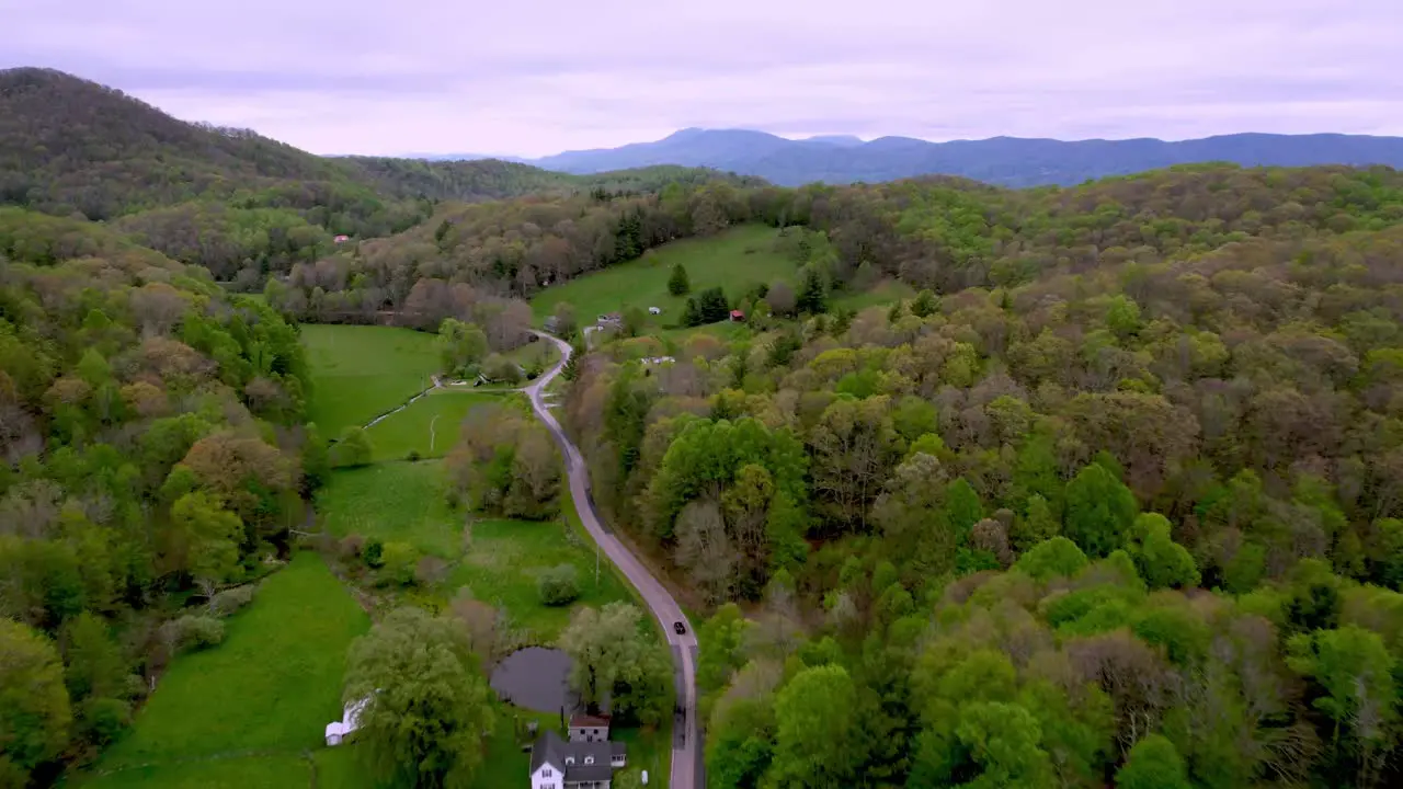 car drives down mountain valley roadway near boone and matney nc north carolina