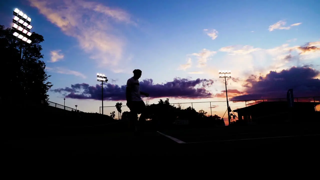 silhouette of a tennis player at sunset serve for win