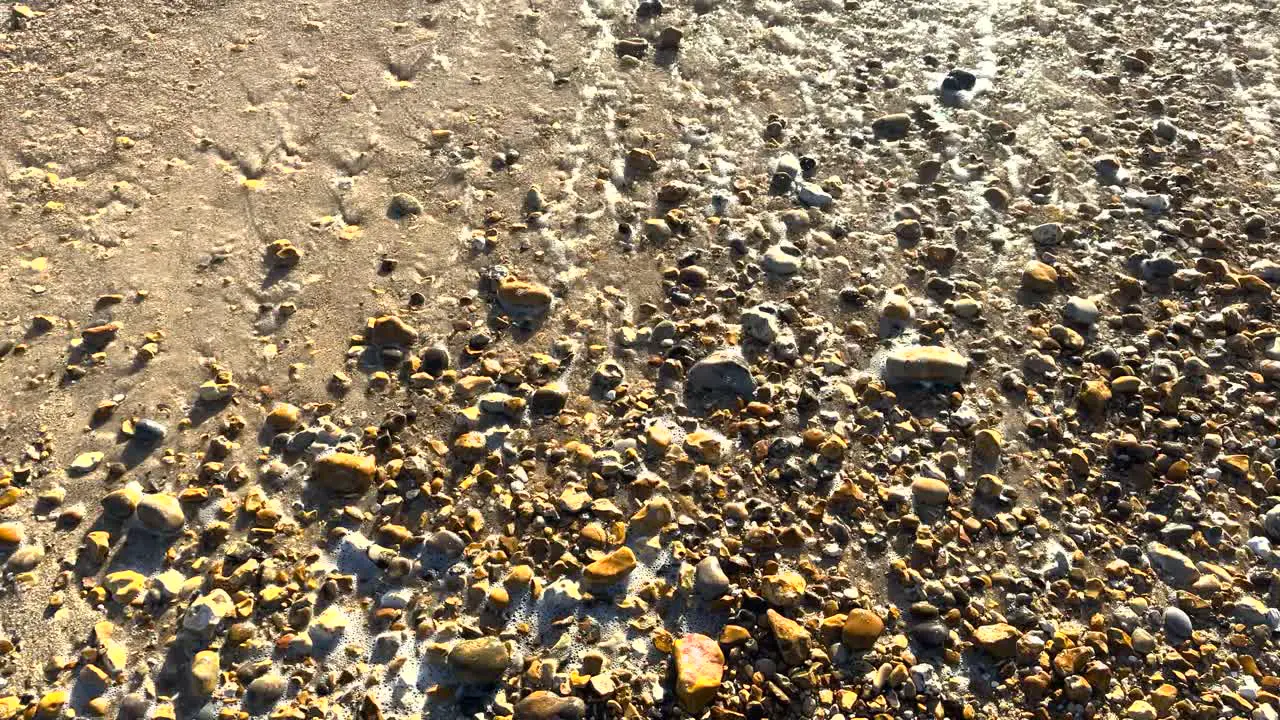 Gentle Waves on a Pebbled British Beach