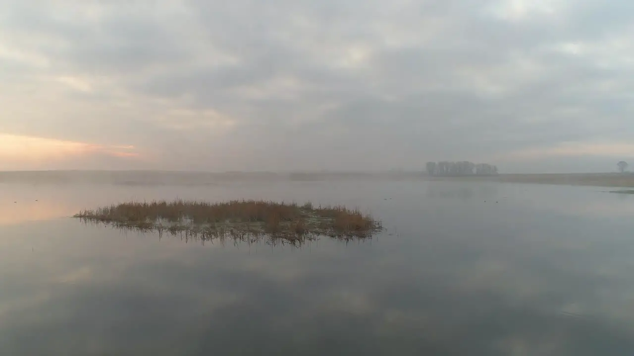 Sunrise Flight Over Misty Lake