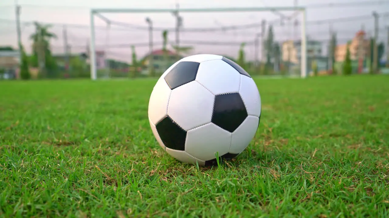 Soccer ball on the football field background