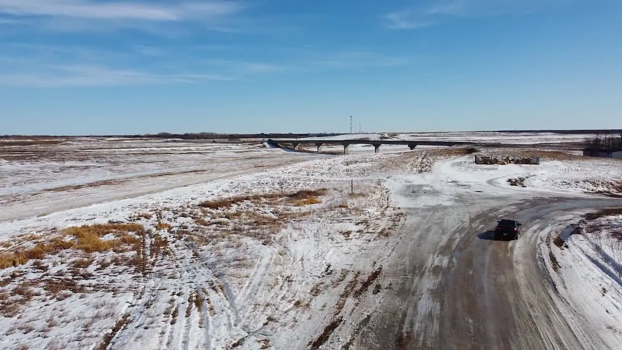 Drone Following Vehicle Going up to Reveal Bridge