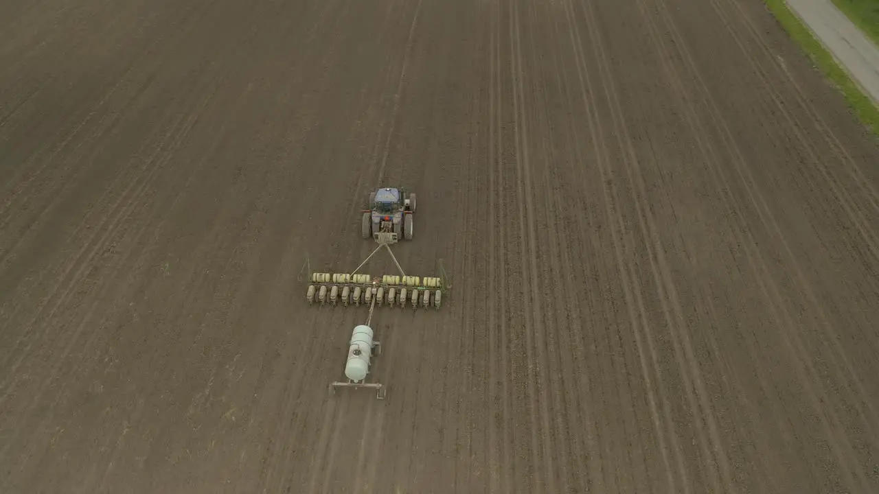 Farmer in tractor planting crop in field take 7