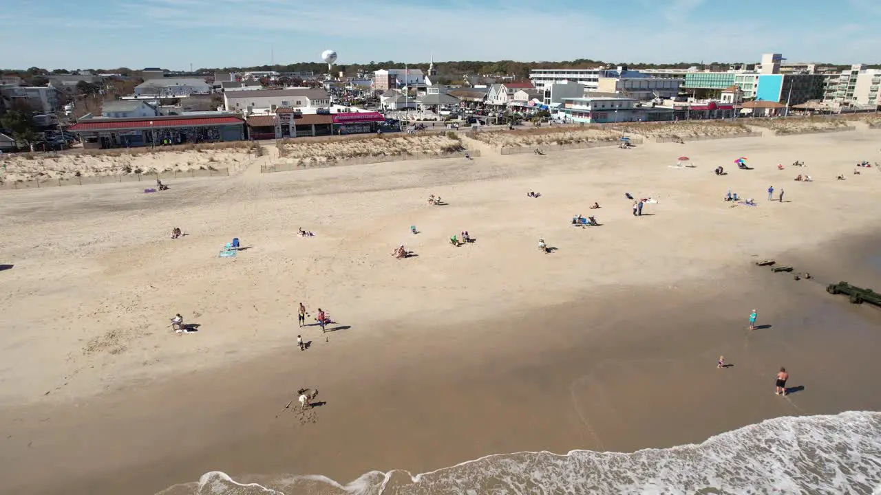 Rehoboth Beach Delaware sunny day drone flyover beach to downtown long shot