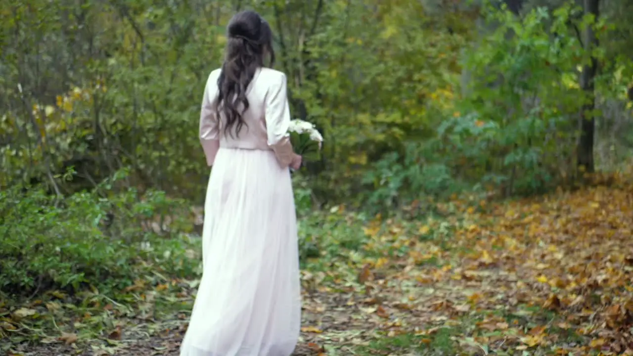 Bride walking in the forest