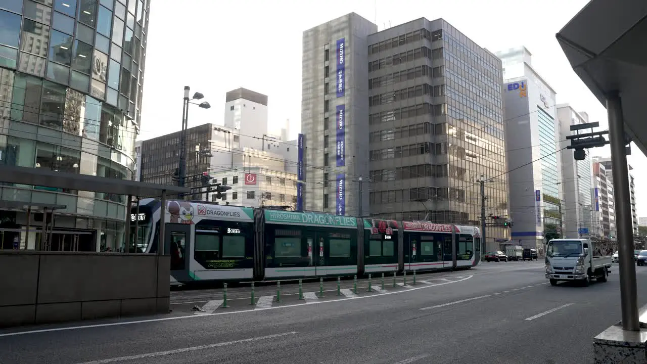 Modern Hiroshima Streetcar Going Past In Downtown Area