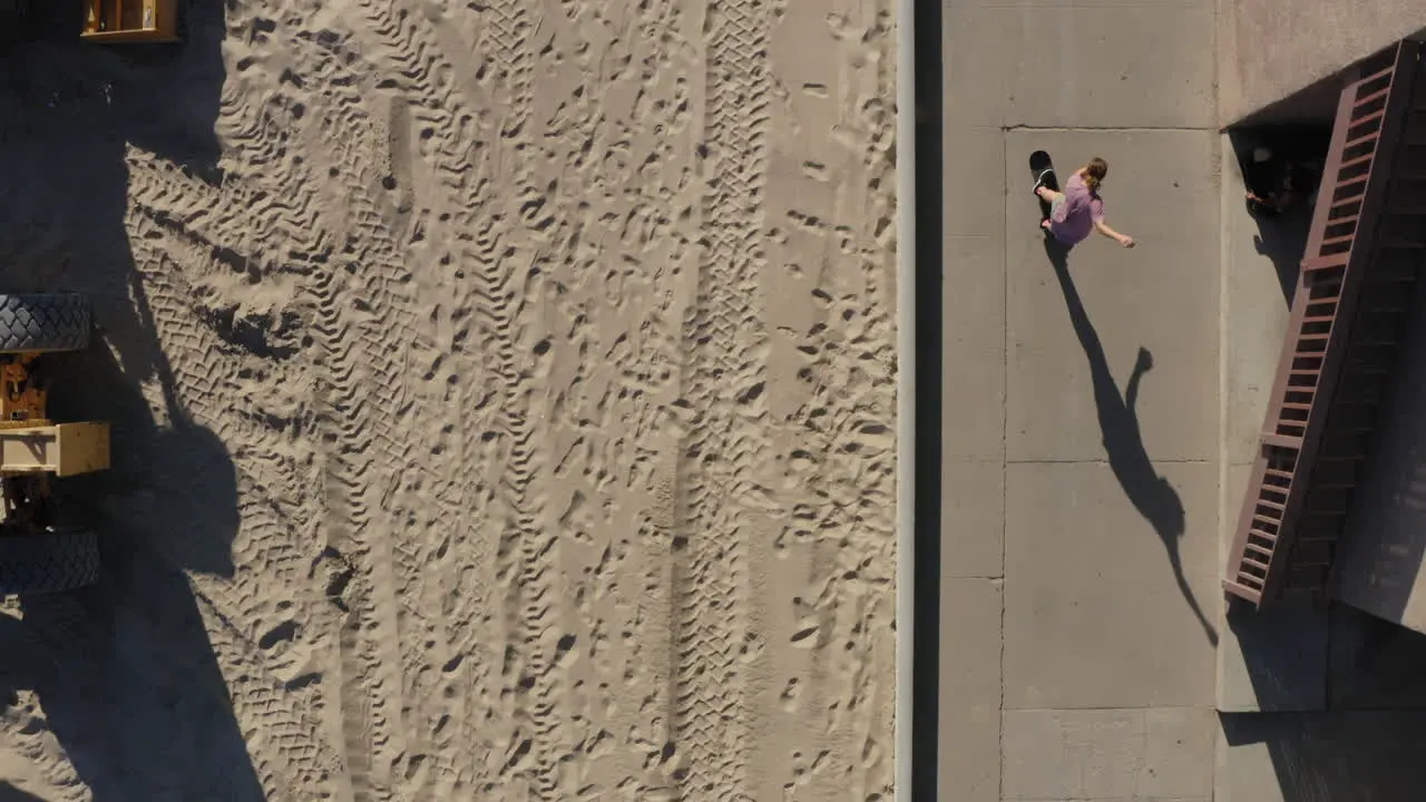 Skateboarding on sidewalk near sandy Seal Beach is Los Angeles aerial view