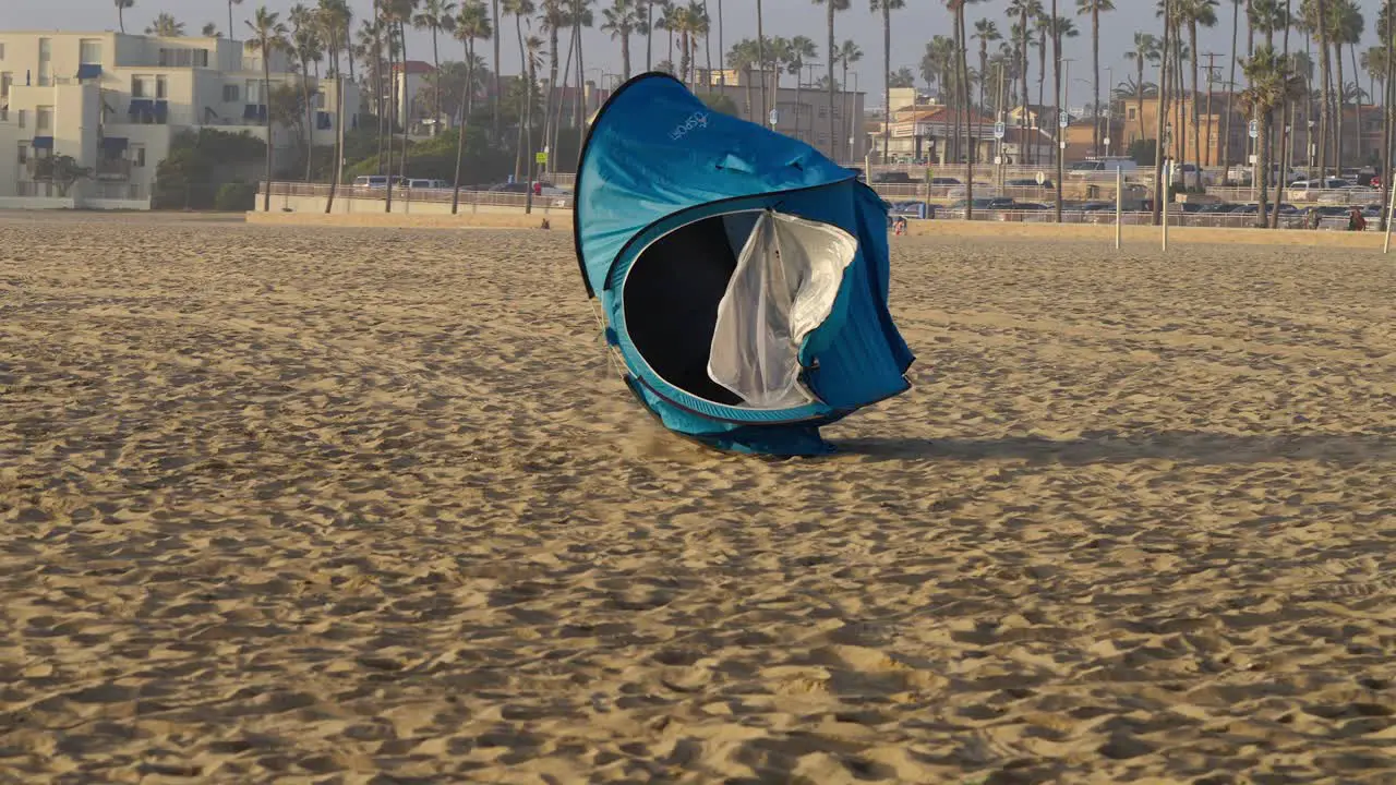 Pop up shelter getting blown across the beach in California