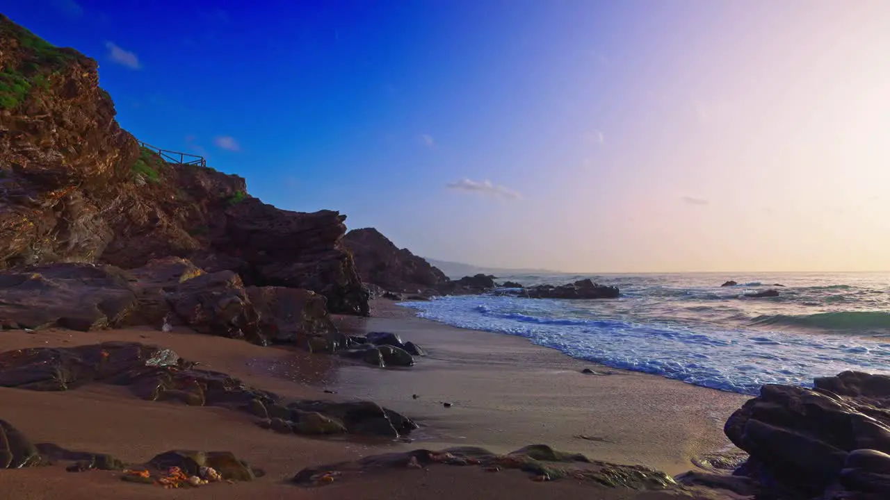 Slow motion waves at a rocky empty beach