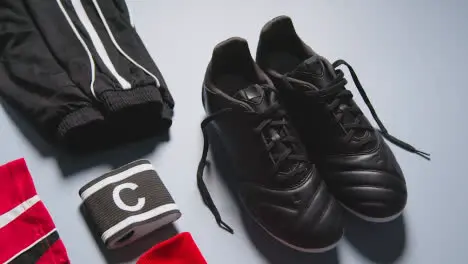 Studio Still Life Shot Of Football Soccer Boots Ball Shirt And Shorts And Captains Armband 3