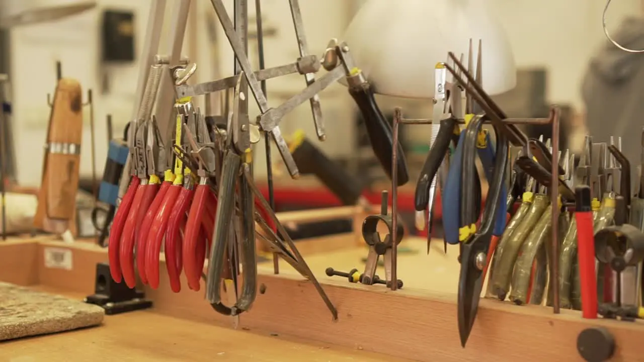 Detail of workroom full of pliers tweezers splitters files and other tools in slow motion