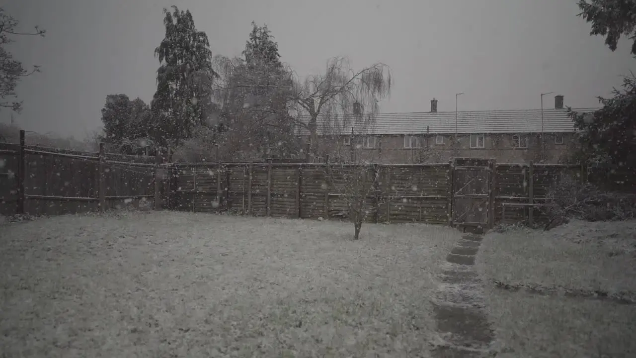 Snow flakes in slow motion covering house garden in cambridge england england uk