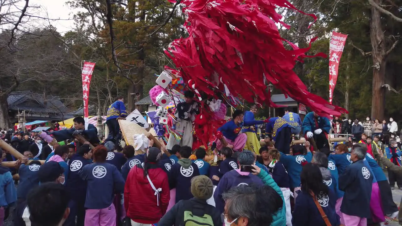 Slow motion shot of Sagicho Matsuri festival float battle with gathered crowd