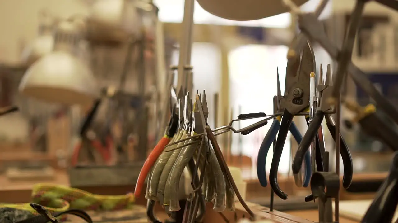 Detail of workroom full of pliers tweezers splitters and other tools in slow motion