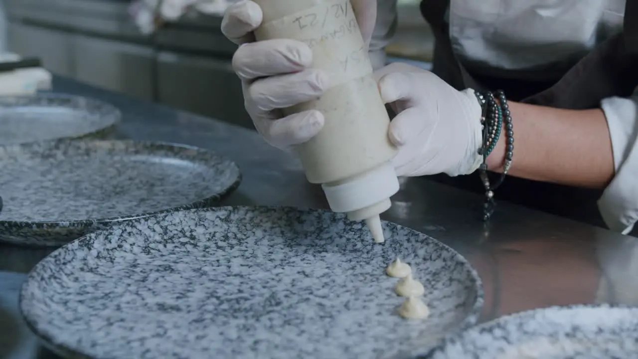 A professional chef is preparing a hamburger in his kitchen 06