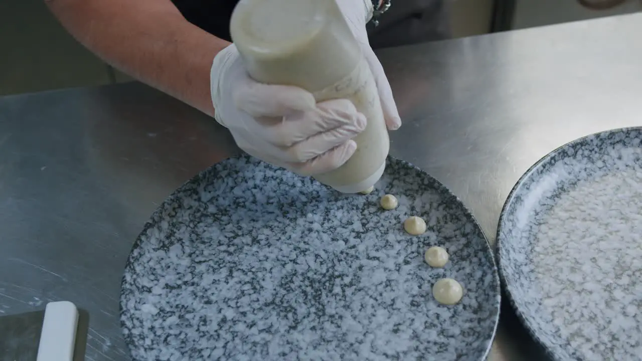 A professional chef is preparing a hamburger in his kitchen 07