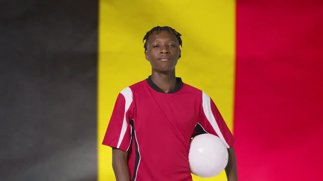 Young Footballer Posing In Front of Belgium Flag 01