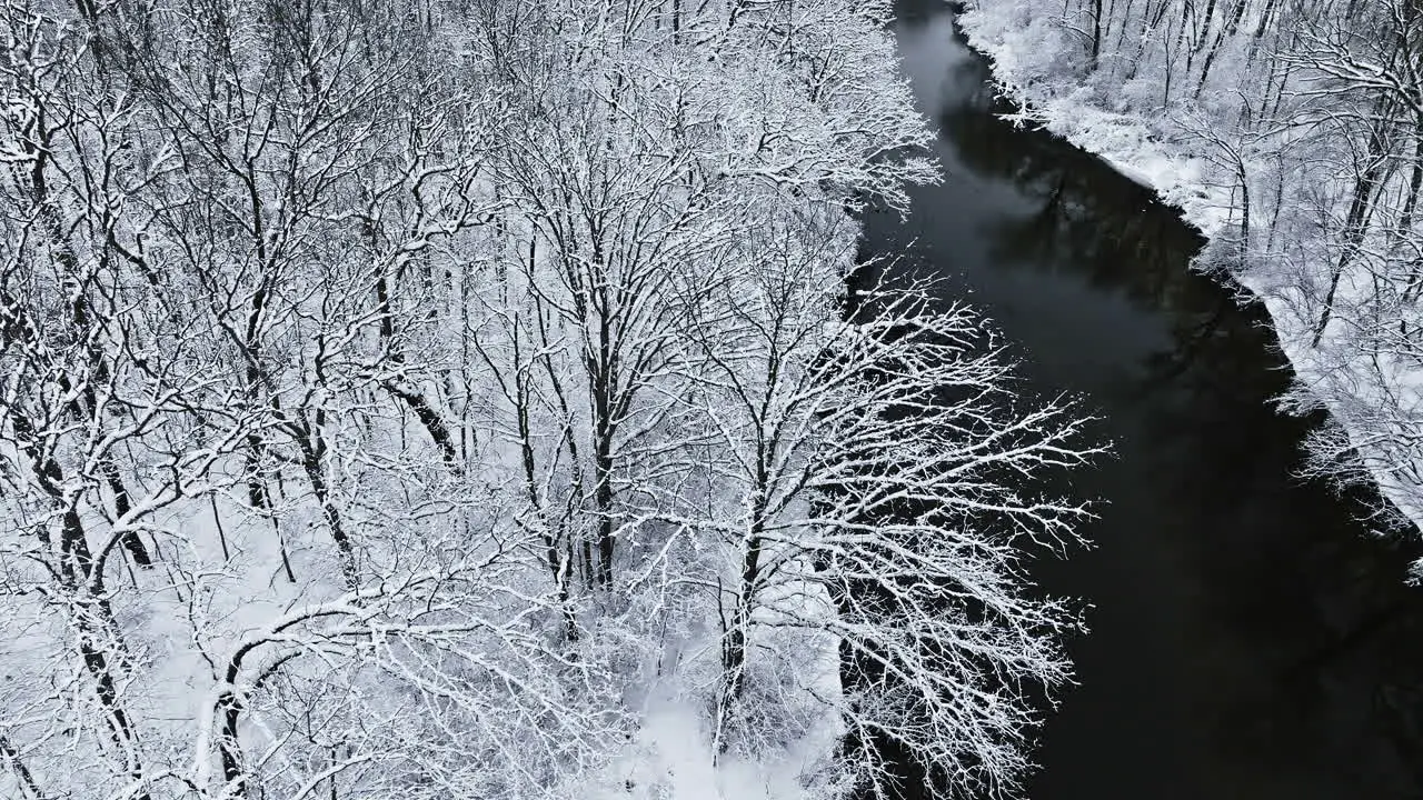 Overhead drone view traversing the pristine winter beauty of the snow-covered Huron River Valley