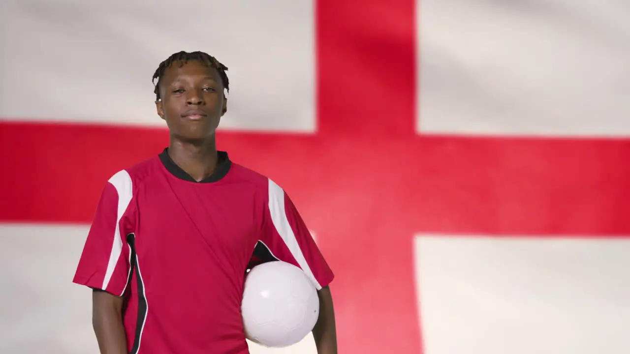 Young Footballer Walking to Camera In Front of England Flag 01