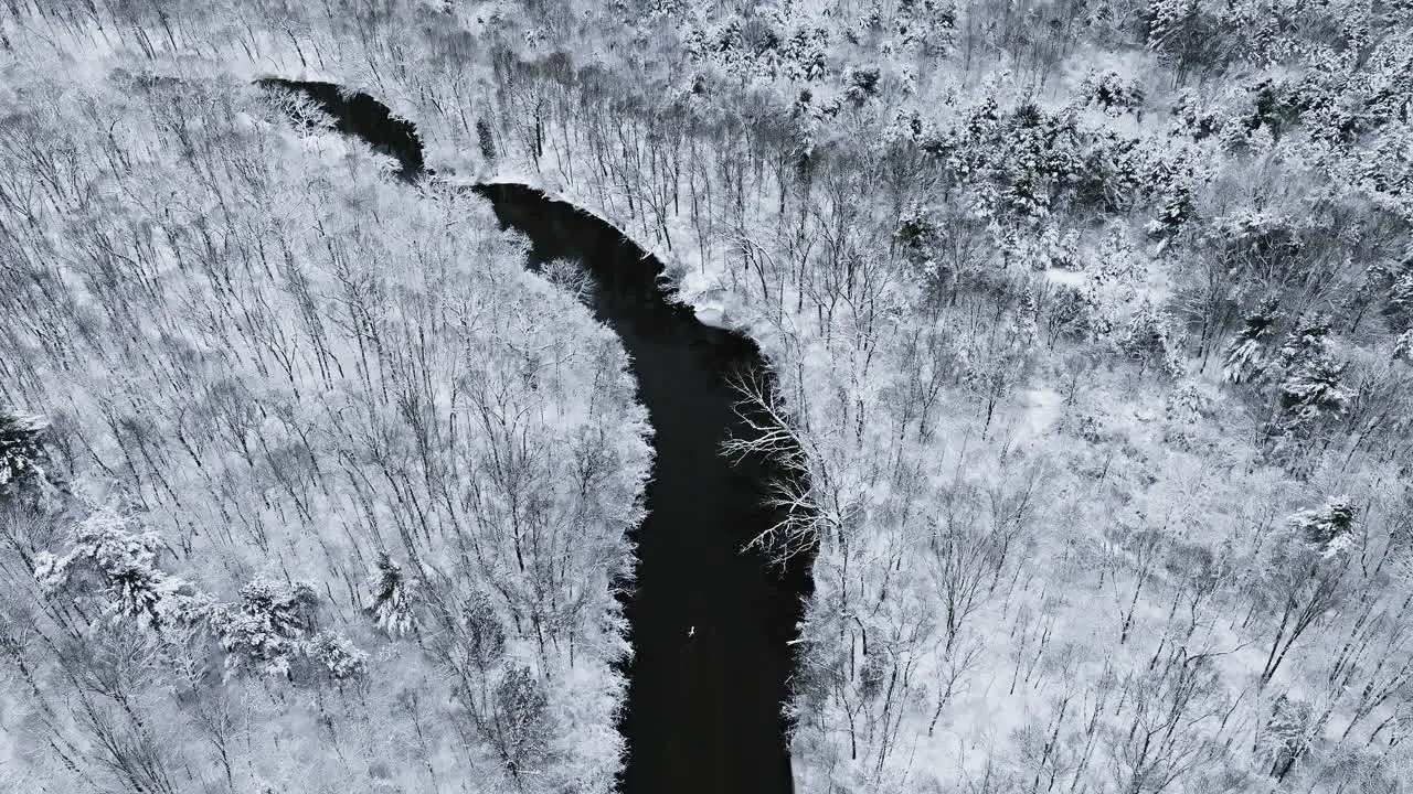 Cinematic drone perspective showcasing the Huron River Valley blanketed in snow from above