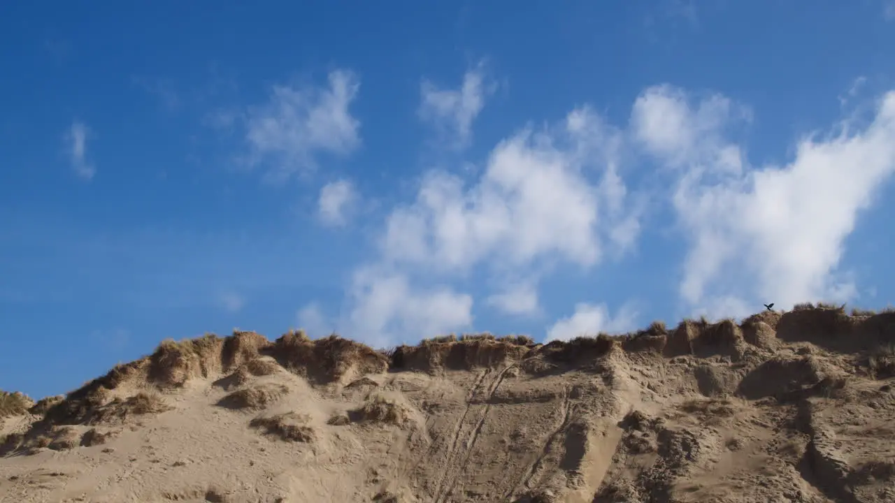 Time lapse of light clouds floating over sand dunes at Crantock Beach