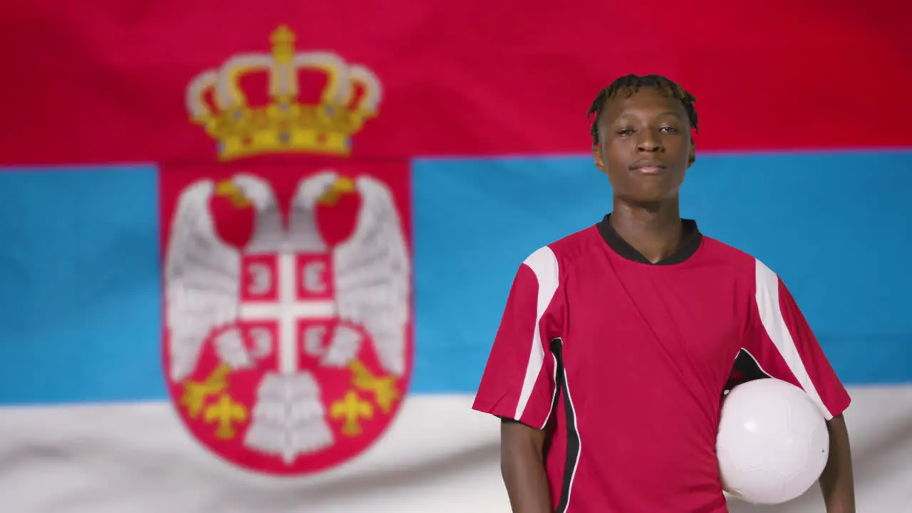 Young Footballer Posing In Front of Serbia Flag 01