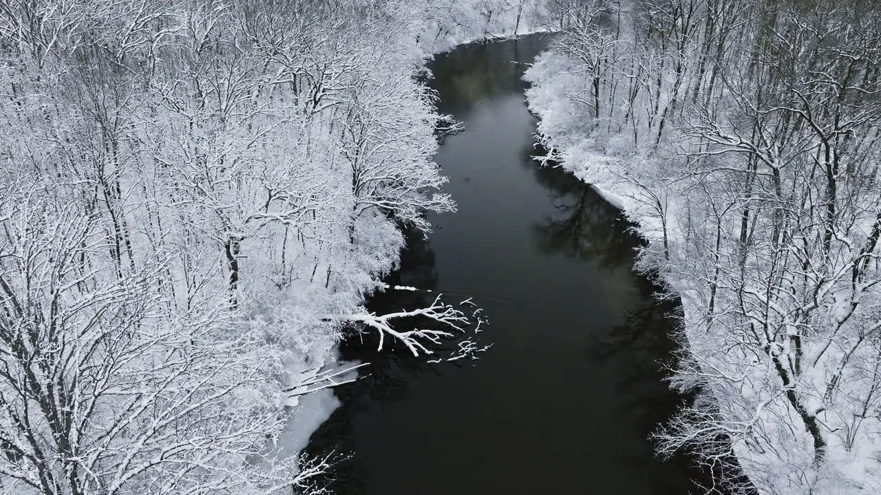 A drone's-eye journey above the snow-covered Huron River Valley capturing its tranquil allure